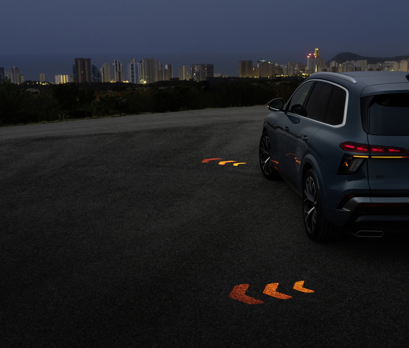 The new Audi Q7 at night projecting its turn signal